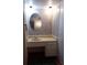 Bathroom vanity with a sink and a decorative oval mirror at 1525 Hilltop Rd, Casselberry, FL 32707