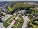 Aerial view of community center featuring a clock tower, green spaces, walking paths, a pool, and a pond at 15647 Braintree Ln, Winter Garden, FL 34787