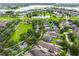 Aerial view of a neighborhood with mature trees, and a scenic pond at 15647 Braintree Ln, Winter Garden, FL 34787
