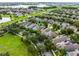 Aerial view of a neighborhood with mature trees, and a scenic pond at 15647 Braintree Ln, Winter Garden, FL 34787