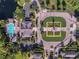 Aerial view of the community center featuring a swimming pool, green space, clock tower, and sidewalks at 15647 Braintree Ln, Winter Garden, FL 34787