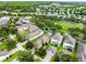Aerial view of a home in a neighborhood with lake views and manicured lawns at 15647 Braintree Ln, Winter Garden, FL 34787