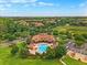 An aerial view of the clubhouse with a large swimming pool and plenty of patio seating at 15647 Braintree Ln, Winter Garden, FL 34787
