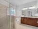 Bathroom with double sink vanity, soaking tub and glass enclosed shower at 15647 Braintree Ln, Winter Garden, FL 34787