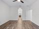Bedroom showcasing arched doorway to bath and wood-look flooring at 15647 Braintree Ln, Winter Garden, FL 34787