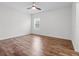 Bright bedroom featuring wood flooring, neutral walls, and a ceiling fan at 15647 Braintree Ln, Winter Garden, FL 34787