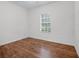 Bedroom featuring wood flooring, natural light from window, and neutral walls at 15647 Braintree Ln, Winter Garden, FL 34787