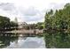 Community clubhouse featuring a picturesque reflection across the lake and lovely trees at 15647 Braintree Ln, Winter Garden, FL 34787