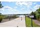 Community lake view from the walking path, scenic water views, lush green vegetation, and clear blue skies at 15647 Braintree Ln, Winter Garden, FL 34787
