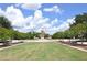 Community park featuring a clock tower, manicured green spaces, a grassy lawn, and walking paths at 15647 Braintree Ln, Winter Garden, FL 34787