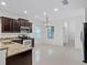 Open kitchen boasts dark cabinetry, granite countertops, and new stainless steel appliances at 15647 Braintree Ln, Winter Garden, FL 34787