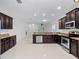 Spacious kitchen featuring granite countertops, stainless steel appliances, and plenty of cabinet space at 15647 Braintree Ln, Winter Garden, FL 34787