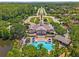 Aerial view showcasing a large swimming pool and a charming clubhouse with patio seating at 15647 Braintree Ln, Winter Garden, FL 34787