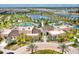 Stunning aerial view of a community featuring a pool, lake, recreational areas, and beautifully landscaped grounds at 1625 Nassau Point Trl, Kissimmee, FL 34747