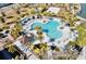 Aerial view of a community pool with a clover shape, lounge chairs, and palm trees at 1625 Nassau Point Trl, Kissimmee, FL 34747
