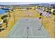 Aerial view of a well-maintained basketball court, soccer fields, and lakeside ampitheater at 1625 Nassau Point Trl, Kissimmee, FL 34747