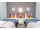 Inviting bedroom featuring two twin beds and whimsical decor for a cozy ambiance at 1625 Nassau Point Trl, Kissimmee, FL 34747