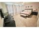 This bedroom features a carpeted floor, a queen size bed, and ample natural light from the windows at 1625 Nassau Point Trl, Kissimmee, FL 34747