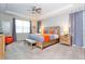 This bedroom features a patterned wall, a king size bed, and two night stands with lamps at 1625 Nassau Point Trl, Kissimmee, FL 34747