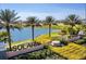 Well manicured entrance to Solara Resort, featuring lush landscaping, a serene lake, and welcoming signage at 1625 Nassau Point Trl, Kissimmee, FL 34747