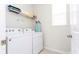 This laundry room features a white washer and dryer, storage shelves and a window at 1625 Nassau Point Trl, Kissimmee, FL 34747