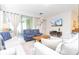 Bright living room featuring stylish furniture and sliding glass doors to the outside at 1625 Nassau Point Trl, Kissimmee, FL 34747