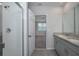 Bathroom featuring double sinks, tiled floors, shower, and neutral paint at 17363 Million Lakes Ct, Clermont, FL 34714