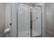 Bathroom features tiled shower with a glass door and white tiled walls at 17363 Million Lakes Ct, Clermont, FL 34714