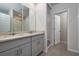 Bathroom featuring double sinks, a tiled shower, neutral paint, and tiled floors at 17363 Million Lakes Ct, Clermont, FL 34714