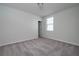 Bright bedroom features neutral paint, carpet floors, and window allowing natural light at 17363 Million Lakes Ct, Clermont, FL 34714