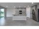 Bright, open kitchen featuring a center island with a sink, stainless steel appliances, and ample cabinet space at 17363 Million Lakes Ct, Clermont, FL 34714