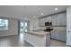 Modern kitchen featuring stainless steel appliances, granite countertops, and a central island with a sink at 17363 Million Lakes Ct, Clermont, FL 34714