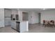 A modern, eat-in kitchen features stainless appliances, granite countertops, and a center island with seating at 17363 Million Lakes Ct, Clermont, FL 34714