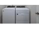 This laundry room features a modern, white, Whirlpool washer and dryer at 17363 Million Lakes Ct, Clermont, FL 34714