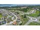 A beautiful aerial view of a residential neighborhood with well-manicured lawns, a community pool, and lush landscaping at 1740 Standing Rock Cir, Oakland, FL 34787