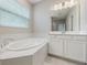 Bright bathroom featuring a large, luxurious soaking tub at 1740 Standing Rock Cir, Oakland, FL 34787