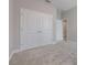 A bedroom with plush carpeting, large closet doors and fresh neutral paint at 1740 Standing Rock Cir, Oakland, FL 34787
