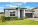 Charming one-story home showcasing a well-manicured lawn and a brick driveway leading to a two-car garage at 1740 Standing Rock Cir, Oakland, FL 34787