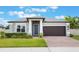 Charming one-story home showcasing a well-manicured lawn and a brick driveway leading to a two-car garage at 1740 Standing Rock Cir, Oakland, FL 34787