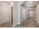 Open hallway featuring wood-look tile floors, arched doorways, and white trim throughout at 1740 Standing Rock Cir, Oakland, FL 34787