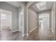 Spacious hallway with wood-look tile flooring, arched doorways, and access to multiple rooms at 1740 Standing Rock Cir, Oakland, FL 34787