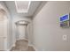 Bright hallway with wood-look tile floors, recessed lighting, skylight, and a smart home control panel at 1740 Standing Rock Cir, Oakland, FL 34787
