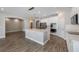 Open-concept kitchen with a large island, stainless appliances, and stylish pendant lighting at 1740 Standing Rock Cir, Oakland, FL 34787