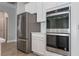 Stainless steel appliances and white cabinets, with tile backsplash, add beauty to this kitchen at 1740 Standing Rock Cir, Oakland, FL 34787