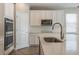 Kitchen featuring stainless steel appliances, white cabinets and countertops, and a large island at 1740 Standing Rock Cir, Oakland, FL 34787
