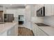 Bright kitchen features stainless steel appliances, white cabinets, and quartz countertops at 1740 Standing Rock Cir, Oakland, FL 34787