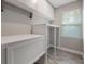 Laundry room with built in shelving, cabinets, and gray wood-look floors at 1740 Standing Rock Cir, Oakland, FL 34787