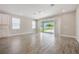 Open-concept living room featuring wood-look tile floors and large sliding glass doors leading to the backyard at 1740 Standing Rock Cir, Oakland, FL 34787