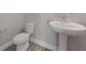 Powder room featuring a pedestal sink, modern faucet, and wood-look tile flooring at 1740 Standing Rock Cir, Oakland, FL 34787