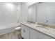 Modern bathroom featuring double sinks, granite countertop, and shower-tub combination at 1797 Archer Dr, Minneola, FL 34715